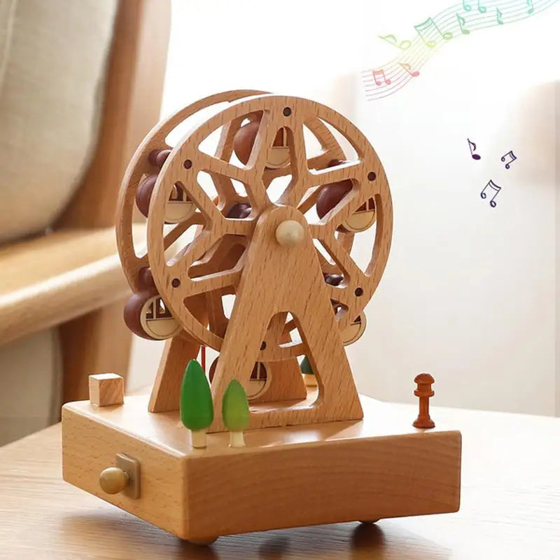 Boîte à musique en bois de hêtre représentant une grande roue avec cabines, posée sur une base rectangulaire.