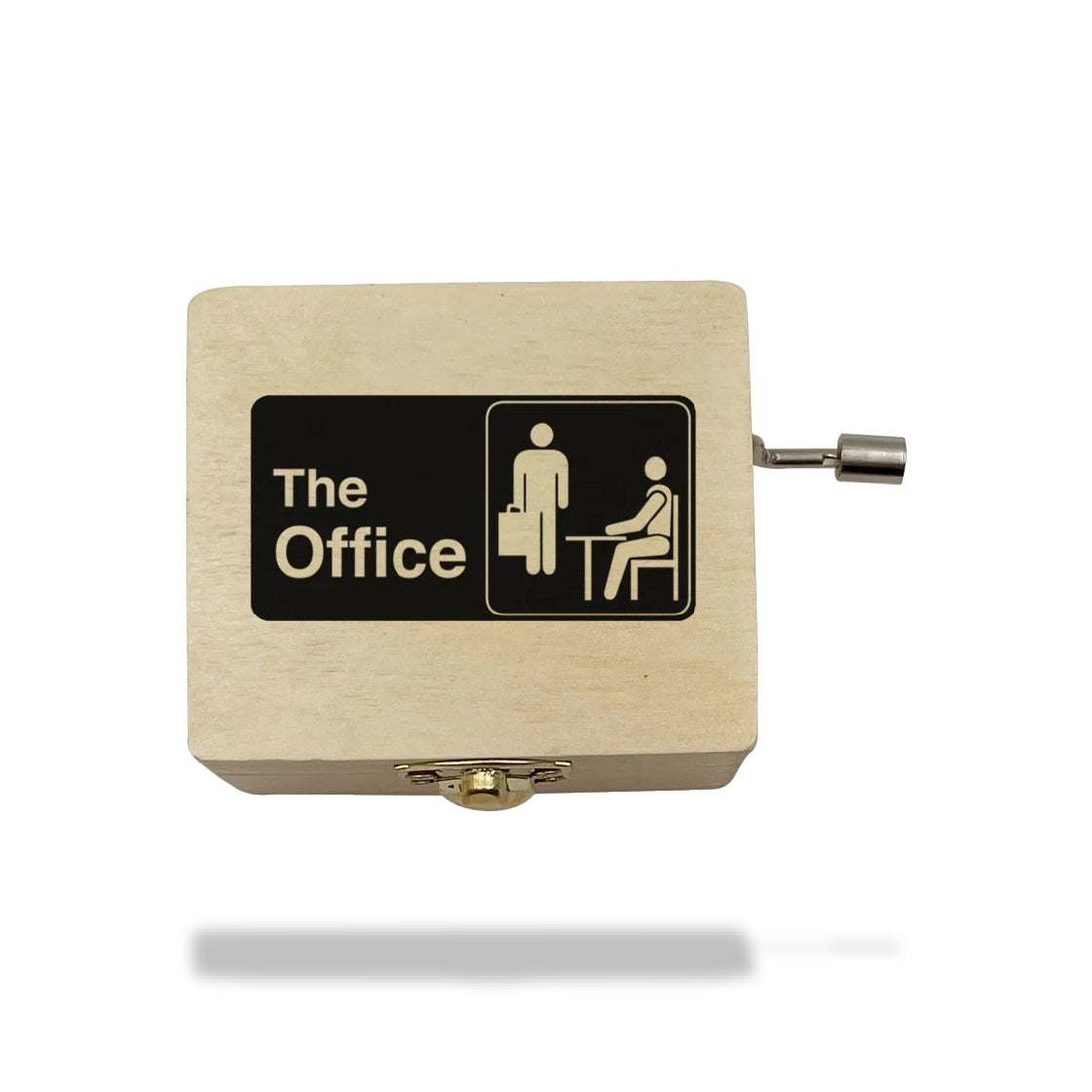 Boîte à musique en bois clair avec manivelle, gravée en noir avec le texte "The Office" et deux icônes.