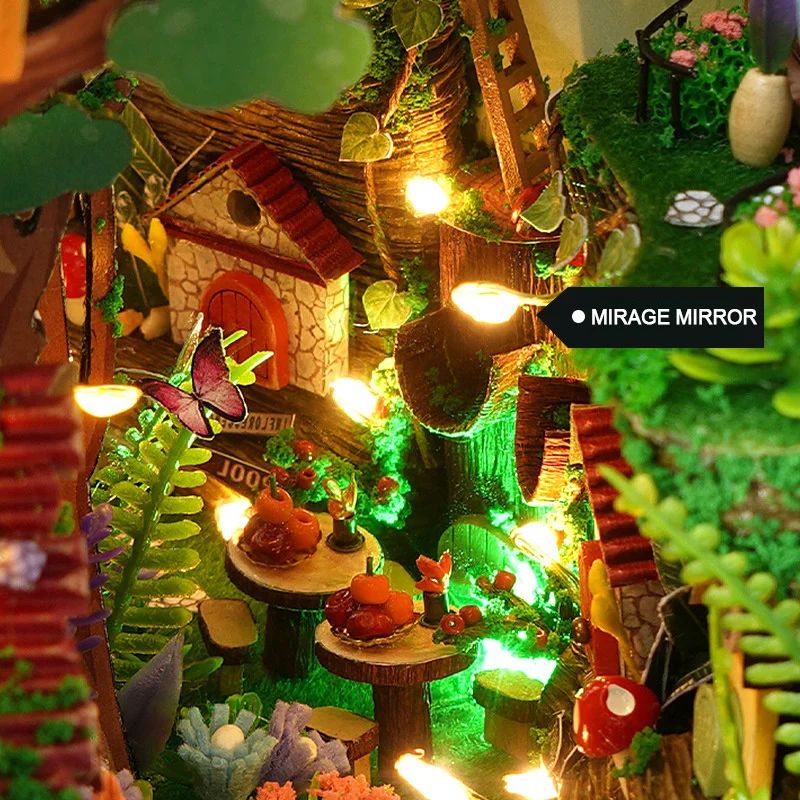 Kit serre-livres miniature lumineux représentant une forêt enchantée avec une maison, une cascade et une table.