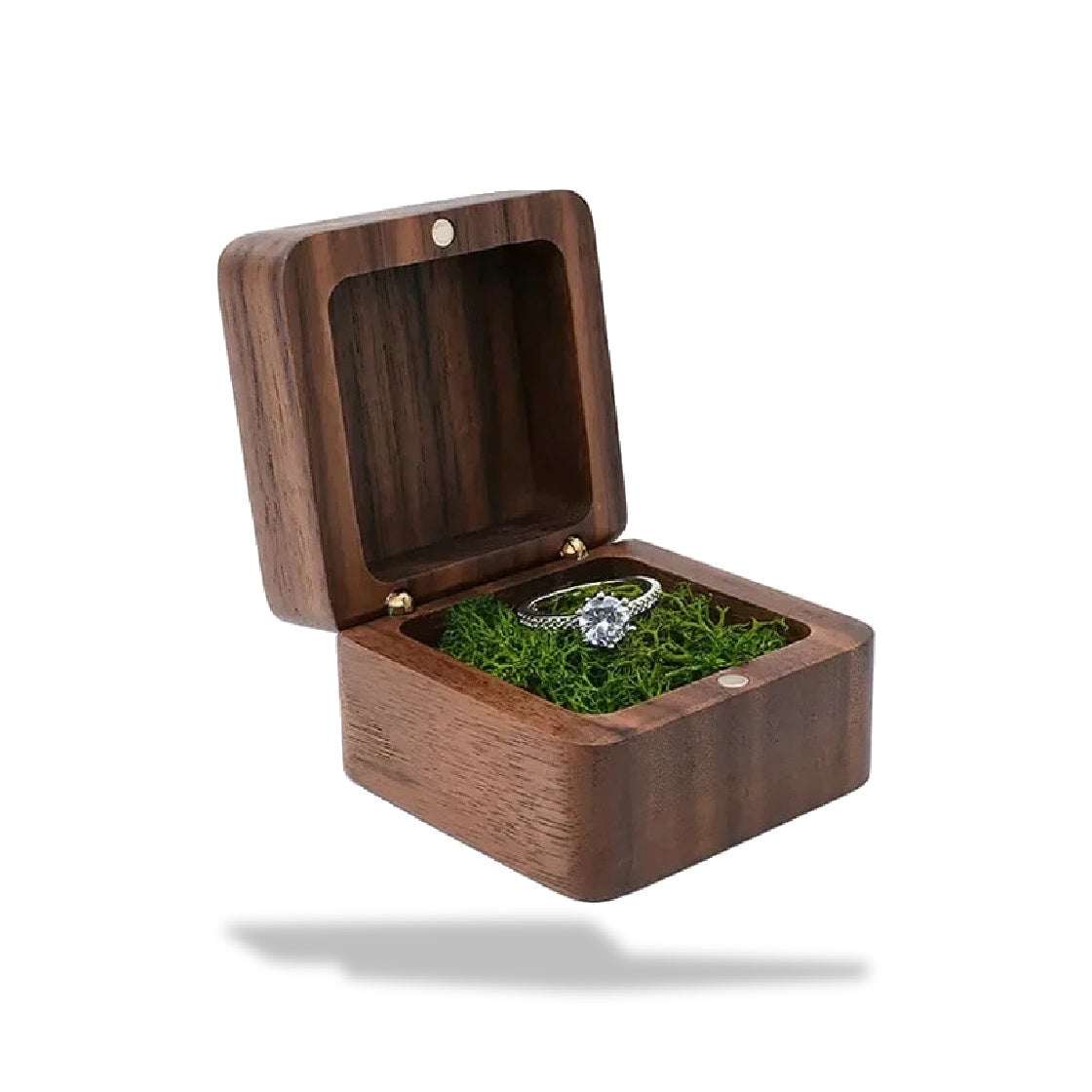 Boîte à bagues en bois brun foncé à charnières avec un aimant. L'intérieur est recouvert de mousse verte, une bague est posée