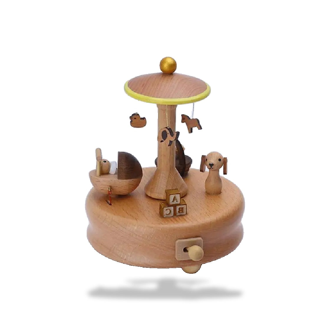 Boîte à musique carrousel enfant en hêtre avec socle rond. Présence d'un berceau et d'un chien sculptés, ainsi que des lettre