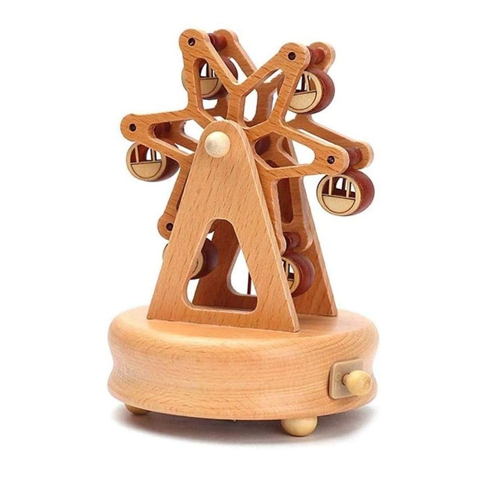 Boîte à musique en bois de hêtre représentant une grande roue avec cabines, sur un socle rond avec pieds. Hauteur 17,3 cm.