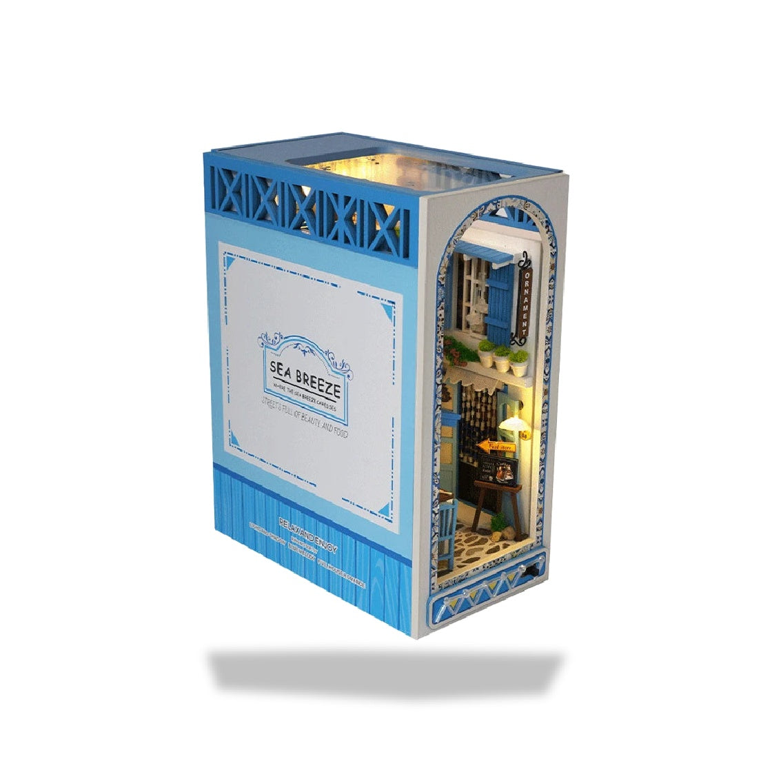 Kit de serre-livres miniature méditerranéen avec lumières LED. Il représente une façade de rue animée, avec fenêtre et enseig