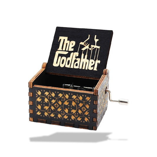 Boîte à musique en bois noir et marron, à manivelle, avec l'inscription « The Godfather » et motifs floraux.