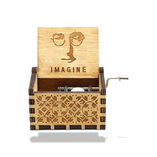 Boîte à musique en bois avec couvercle ouvert, décorée d'un visage stylisé et du mot "IMAGINE".