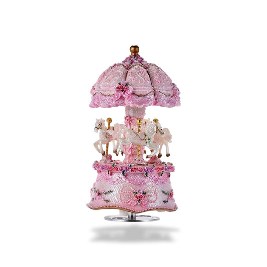Boîte à musique carrousel rose de 16 cm de hauteur avec trois chevaux blancs, décorée de LED et de fleurs.