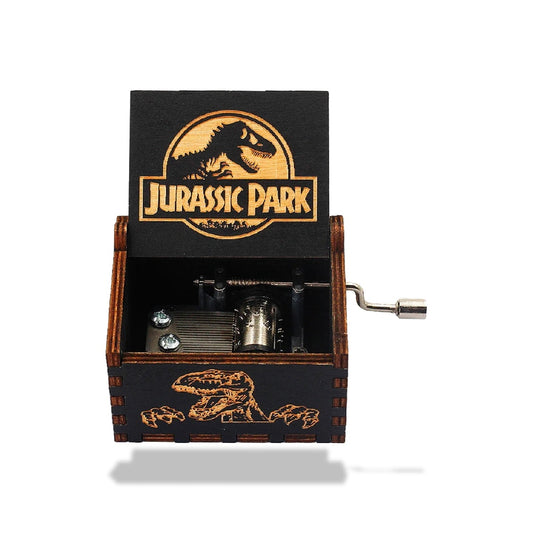 Boîte à musique en bois noir Jurassic Park avec gravure laser du logo et d'un dinosaure, manivelle sur le côté.