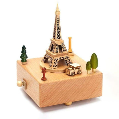 Boîte à musique en hêtre clair avec la Tour Eiffel et une voiture miniature sur le dessus, jouant la mélodie Encounter.