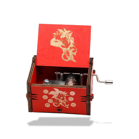 Boîte à musique Dragon Ball Z en bois rouge à manivelle. Motif Goku Super Saiyan gravé sur le couvercle et le côté.