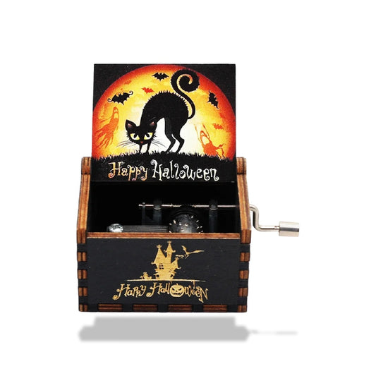 Boîte à musique en bois noire, motif Halloween. Chat noir devant lune orange, château hanté doré, manivelle.